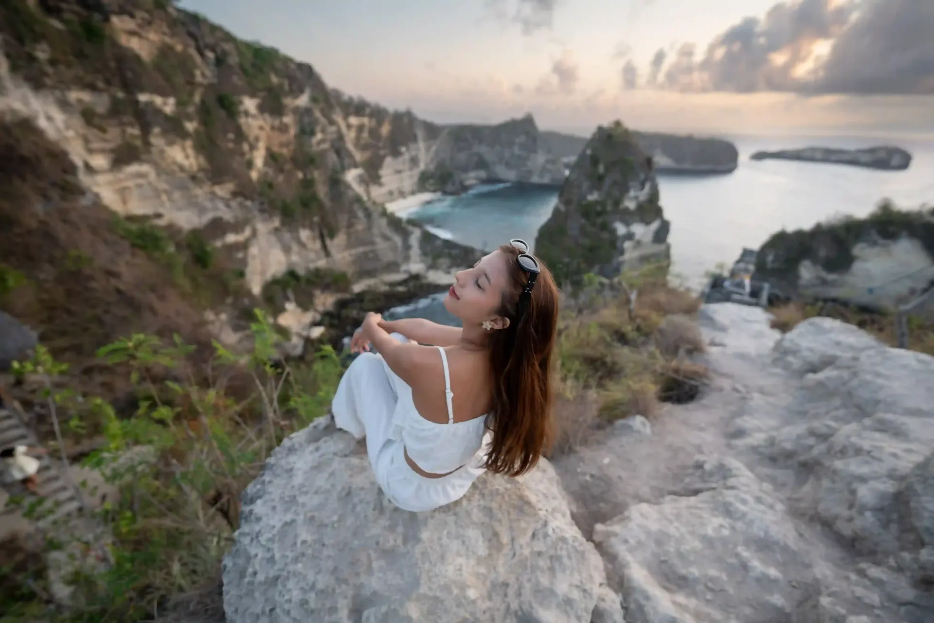 Guest watching the sunset over a Nusa Penida cove